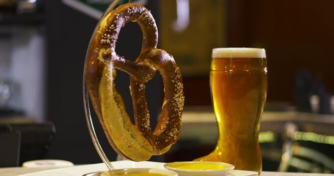 glass of beer with a pretzel