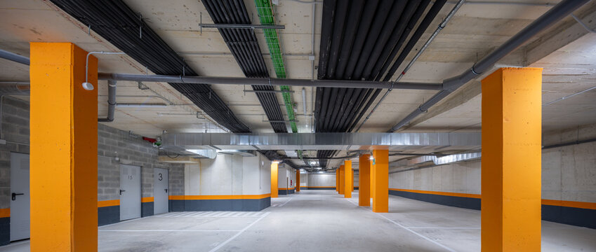 Bright orange pillars in a modern parking garage