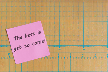 Colored paper note with adhesive tape with motivational phrases, post it glued on a very nice wooden board, copy space