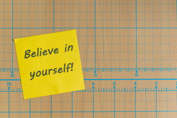 Colored paper note with adhesive tape with motivational phrases, post it glued on a very nice wooden board, copy space