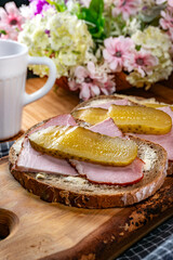 Sandwich with ham, cheese and pickled cucumber.