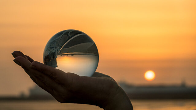 Reflective sunset in crystal ball illustrating perspective in Porto