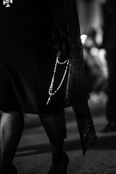 Black and white photograph featuring rosary beads in holy week