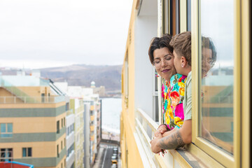 Lesbian couple enjoying a moment on a modern urban balcony