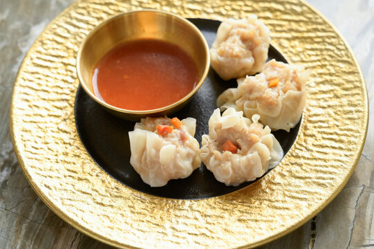 Close-up of delicious Asian dumplings on a golden plate