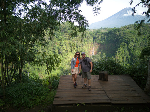 Couple enjoying a scenic view from Kaspa Biru Waterfall platform