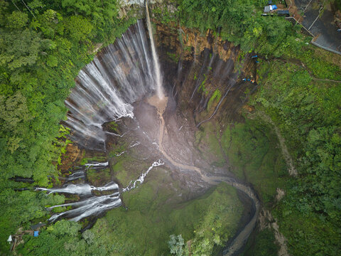 Aerial view of the majestic Tumpak Sewu Waterfall in lush greenery