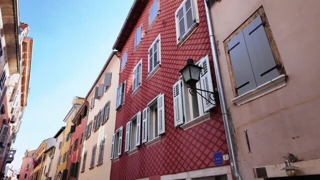 Colourful houses, old facades, beautiful street lamps in the old town of Rovinj, Croatia. Narrow street scenery with beautiful historic residential apartments. Looking from left to right.