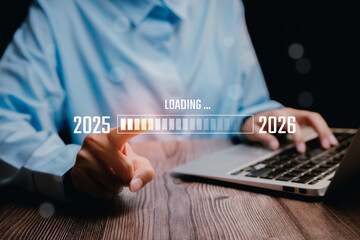 Digital Interface Progress Bar Loading from 2025 to 2026 with Hands on Laptop Keyboard, Business concept