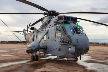 Military Helicopter Stationed on Wet Runway at Torrejon Air Base