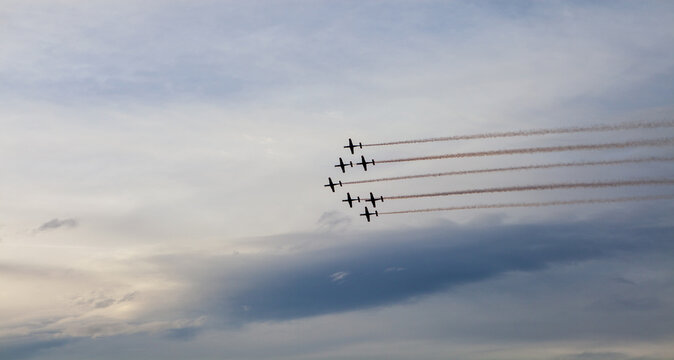 Aerial Display Formation Against Dramatic Sky Backdrop