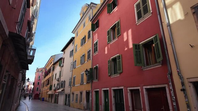 Colourful houses, old facades, beautiful street lamps in the old town of Rovinj, Croatia. Narrow street scenery with beautiful historic residential apartments. Looking from left to right.