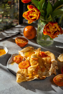 Delicious crepes Suzette with caramelized blood orange sauce