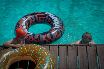 kids wearing goggles are playing with rings in a swimming pool