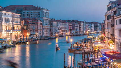 Grand Canal in Venice, Italy day to night timelapse. Gondolas and city lights from Rialto Bridge.