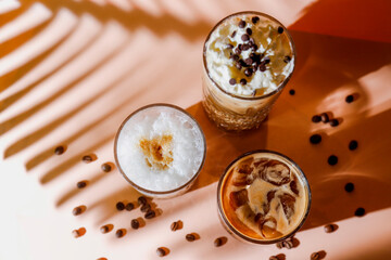 Ice coffee in a tall glasses with coffee beans around.