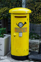 Classic yellow cypriot post box used for sending letter mail
