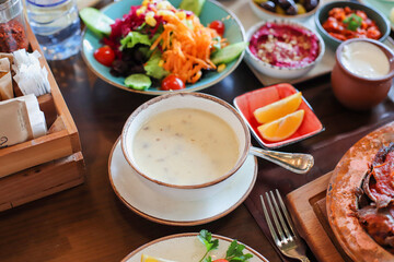 Azerbaijan traditional cuisine dovga, cooked from yoghurt and greens.