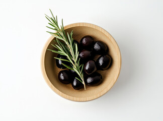 Black olives and rosemary in wooden bowl on white background. Product presentation still life flat lay.
