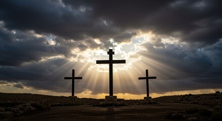 Obraz premium Three wooden crosses standing against a dark cloudy sky with heavenly light rays shining symbolising faith salvation Christianity hope divine inspiration religious crucifixion scene