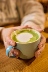 Experience an Elegant Matcha Latte with a Beautiful Creamy Pattern in a Cozy and Inviting Setting