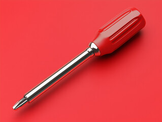 Fototapeta premium Screwdriver isolated on a red background