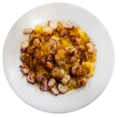 Cooked Spanish octopus with potatoes on a white plate. Traditional Galician dish Pulpo a la gallega flatlay. Spanish seafood dish. Isolated over white background