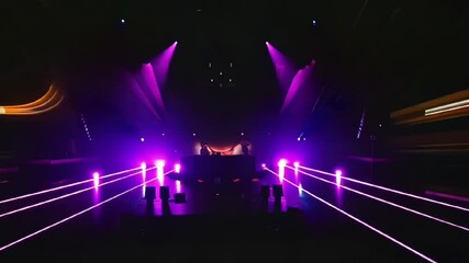 concert stage with purple neon lights and glowing beams creating a vibrant party atmosphere with audience in dark background