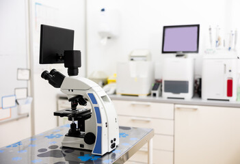 Microscope with multiple magnification, additional liquid crystal monitor screen are installed on desktop. Modern equipment with diagnostic equipment of veterinary clinic laboratory.
