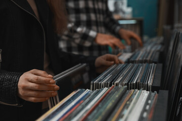 People choosing vinyl records in store, closeup