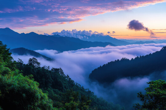 Colorful sunset illuminating rolling clouds over majestic mountain peaks