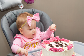 Baby Girl Smashing Birthday Cake in High Chair