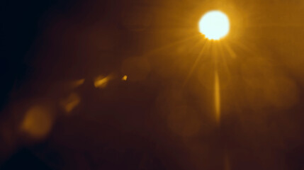Light ray or sun beam bokeh background. Abstract gold light sparkle flash spotlight backdrop golden sunlight shine isolated on black background Overlay flare light effect sunlight lens rays flare © Maxim Chuev