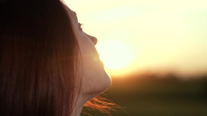 girl look sky sunset gaze, girl look sky thoughtful horizon, girl look sky golden hour reflection, woman praying god contemplating dusk, religious person profile against sun, woman face look up