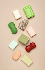 Assortment of colorful toilet moisturizing soap on pink background. Soft light, top view