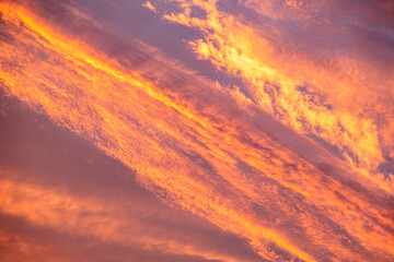 Stunning dramatic sunset sky with golden clouds and pink and purple texture
