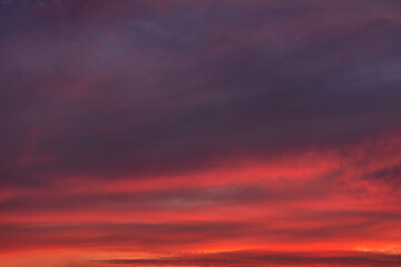 Stunning dramatic sunset sky with golden clouds and pink and purple texture