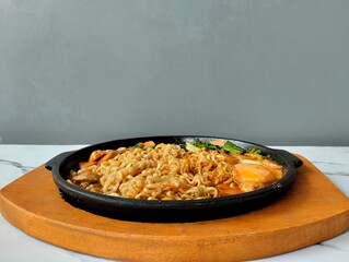 Hot Noodles with Egg and Vegetables on a hot plate