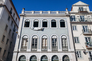 A historic facade in downtown Lisbon covered with iconic azulejo tiles