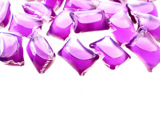 Purple color washing pods on white background. Hygiene product for use in washing machine.