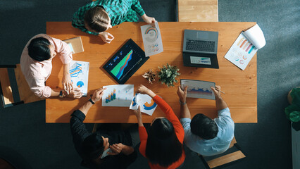 Top down view of business woman explain and present financial chart. Diverse group discuss and listen presentation about stock market statistic at meeting table with investment graph. Convocation.