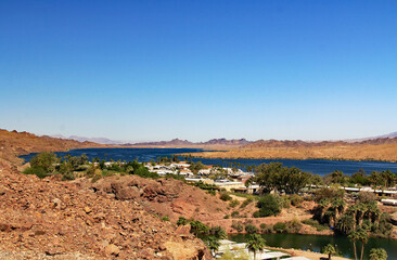 View of Lake Havasu and Colorado River with homes near Lake Havasu City, Arizona, USA with view of California and blue sky copy space.