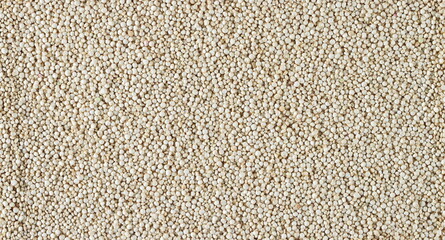 Raw white quinoa seeds background and texture