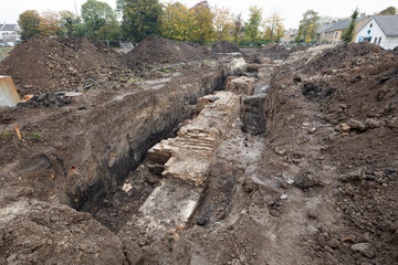 Excavation reveals ancient city walls in historic site, showcasing remnants of cultural heritage