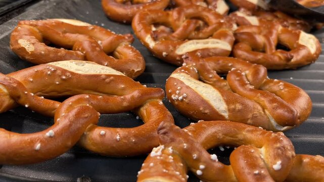 Freshly baked preztel bread on baker's shelf, tracking shot on bretzel