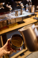 An Artisan Barista Skillfully Preparing a Beautiful Latte with an Intricate Milk Foam Design