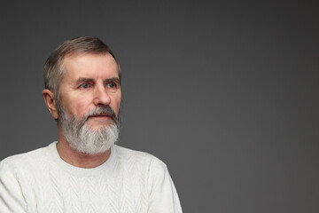 Obraz premium Portrait of mature man on grey background, space for text