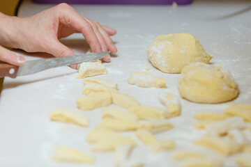 Hands making noodles