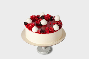 Bright, beautiful red berry cake lying on a cake stand. Isolated image. Cooled cake. Ice cream cake