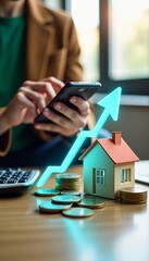 Fototapeta premium Real estate growth depicted by model house rising graph and mobile phone